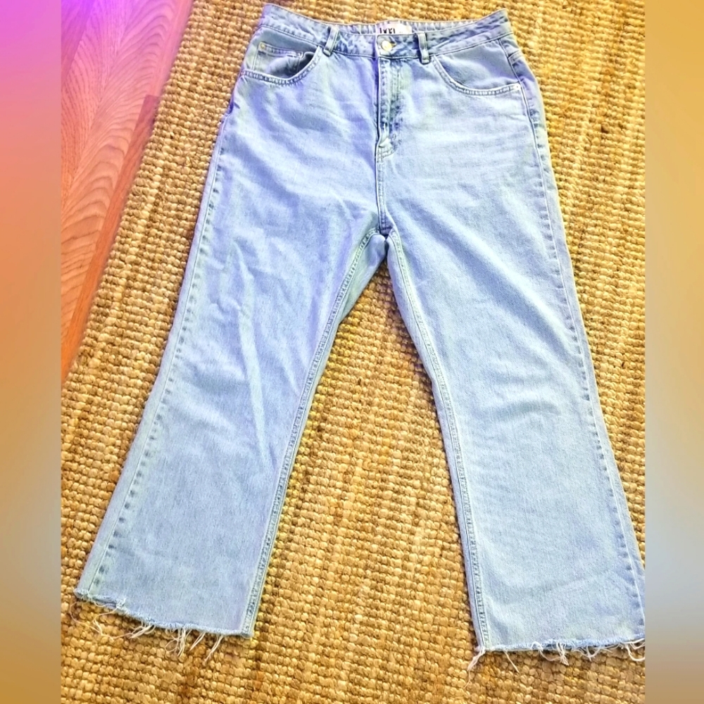 Boa lightwash, wide legged jeans, cut/shredded at ankles, size Large, W 32
